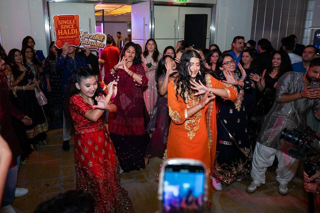 People dancing at Farzi Sangeet a fake indian wedding party at Shangri La