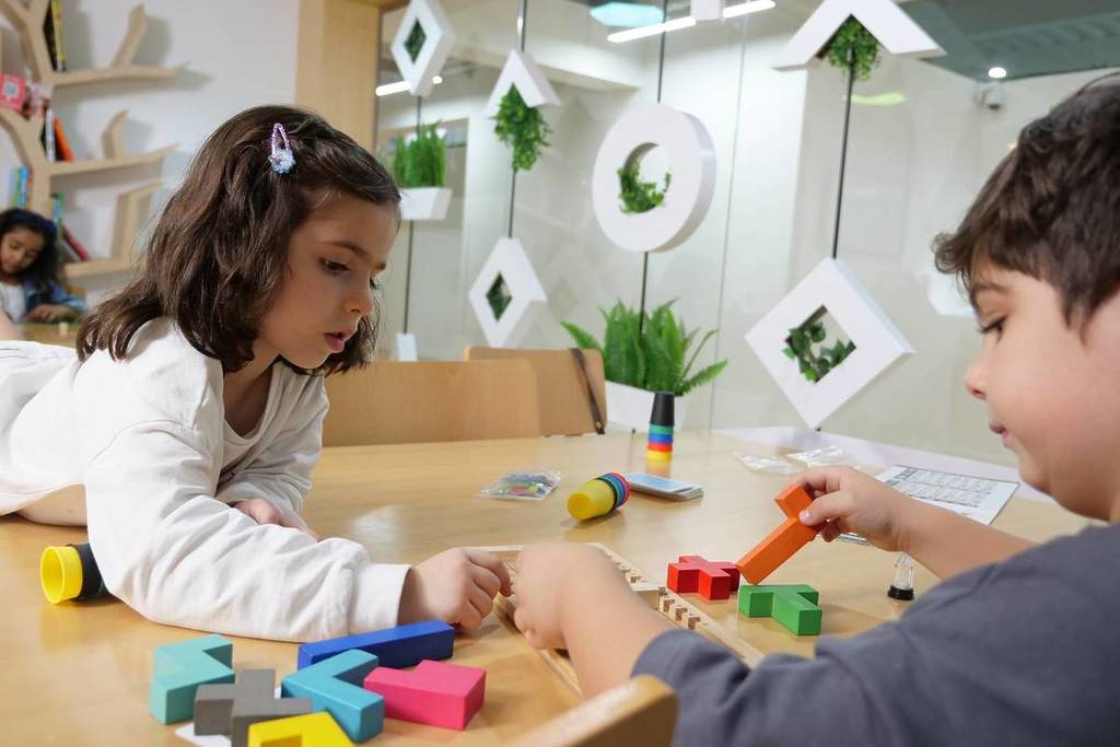 Two children playing with blocks at The Nest, the on-site cafe