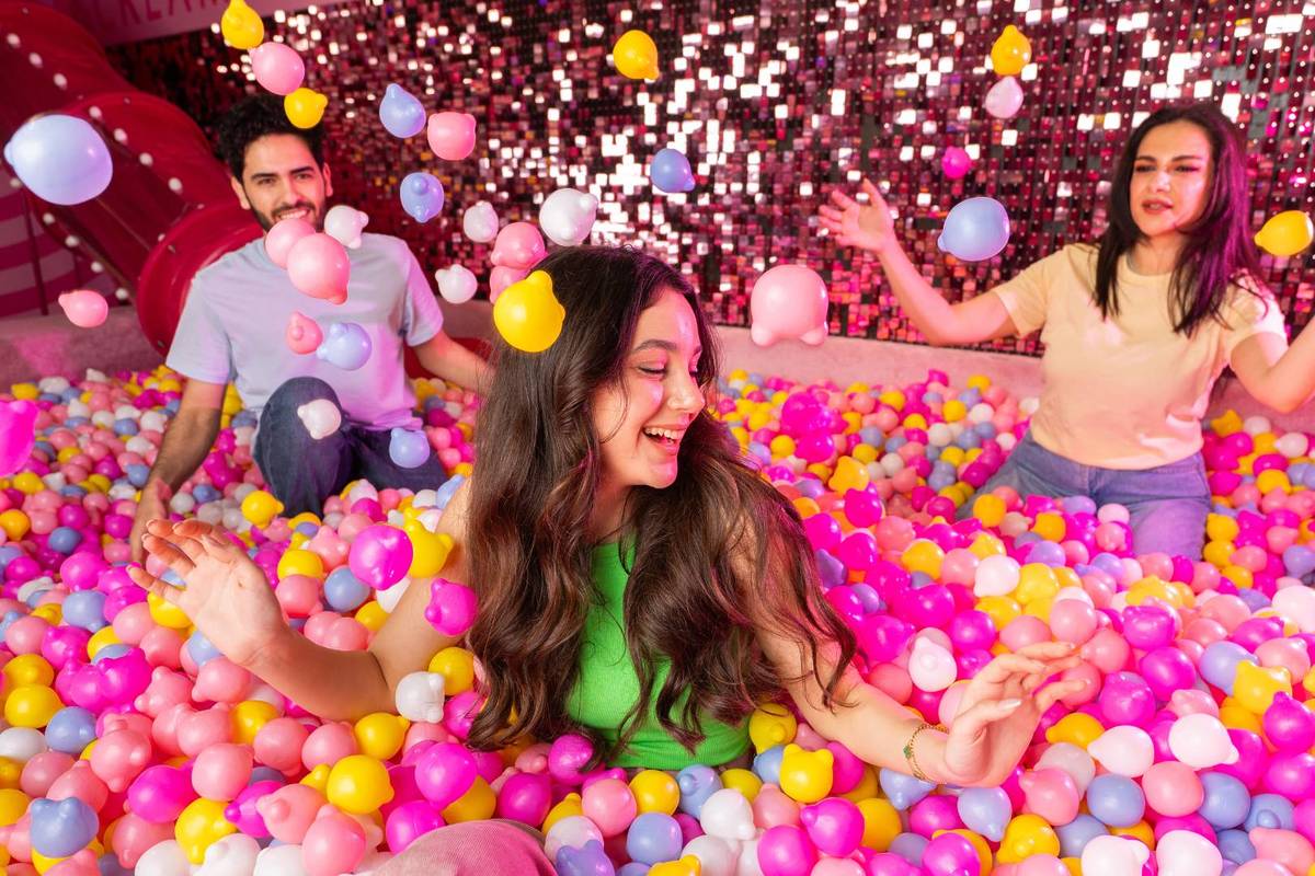 A group of guests playing in the Museum of Candy's ball pit room, one of the sweetest activities to do during the school holidays