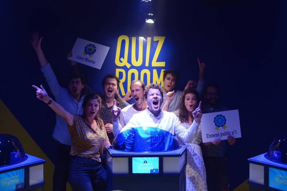 A group of contestants celebrating their win at Quiz Room, a great trivia activity for the school holidays
