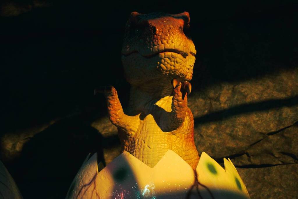 A baby Tyrannosaurus animatronic emerging from an egg