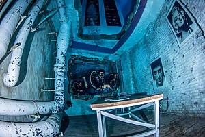 Scuba diver exploring the underwater city inside Deep Dive Dubai’s 60-metre pool