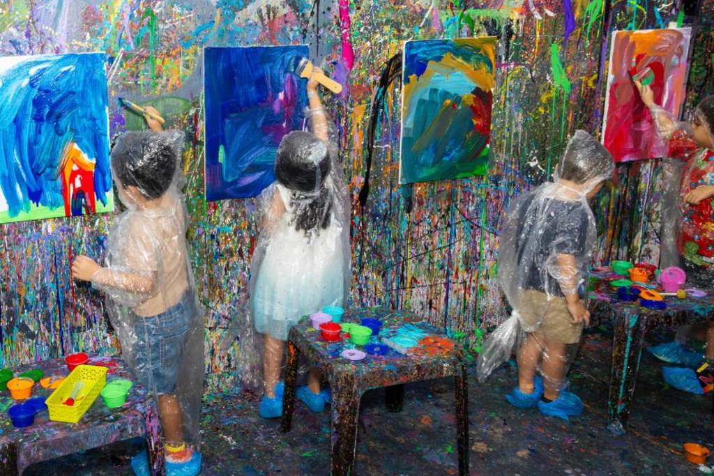 A group of children painting canvases without creative limitations 