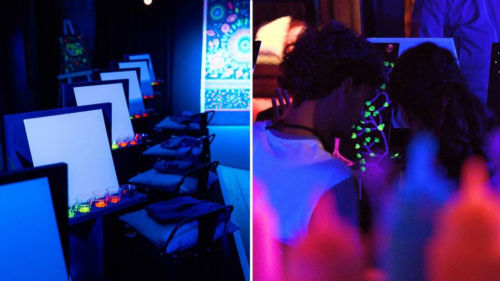 On the left: a row of empty canvases. On the right: the back of two people painting with neon paints an colours