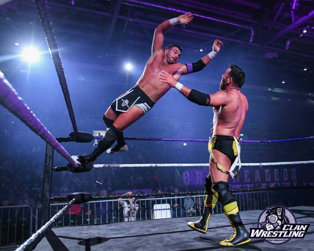 two men wrestling in an arena