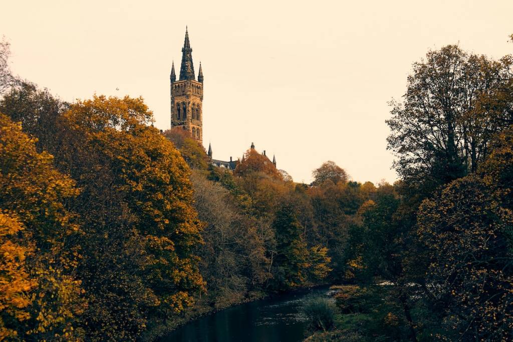 An image of autumn foliage and a castle in Glasgow