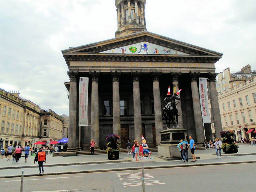 Outside the Gallery of Modern Art, on a cloudy day, with people milling around the square