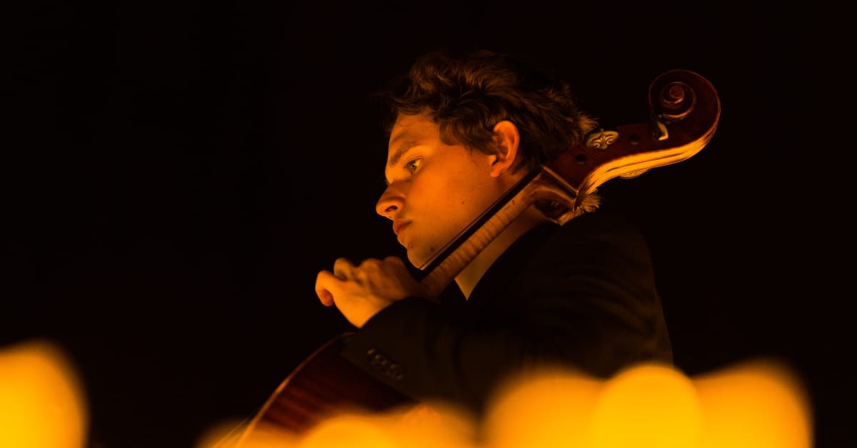 A musician playing the cello at a Candlelight concert
