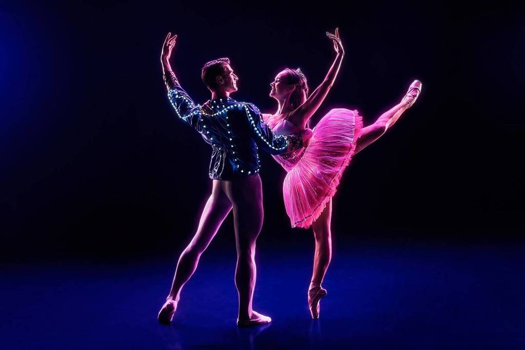 Two ballet dancers in glowing costumes at Ballet of Lights