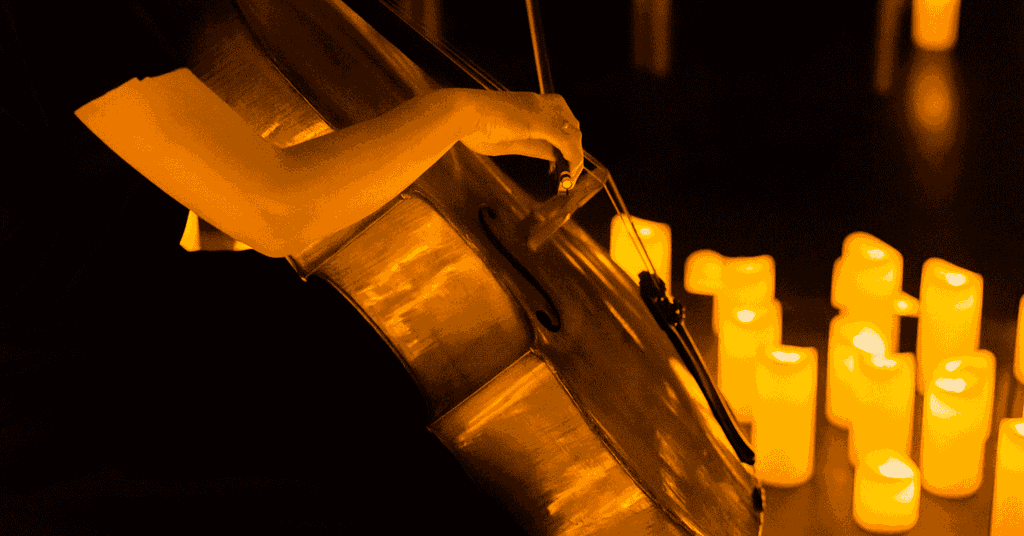 A close up of a musician playing the cello at a Candlelight concert