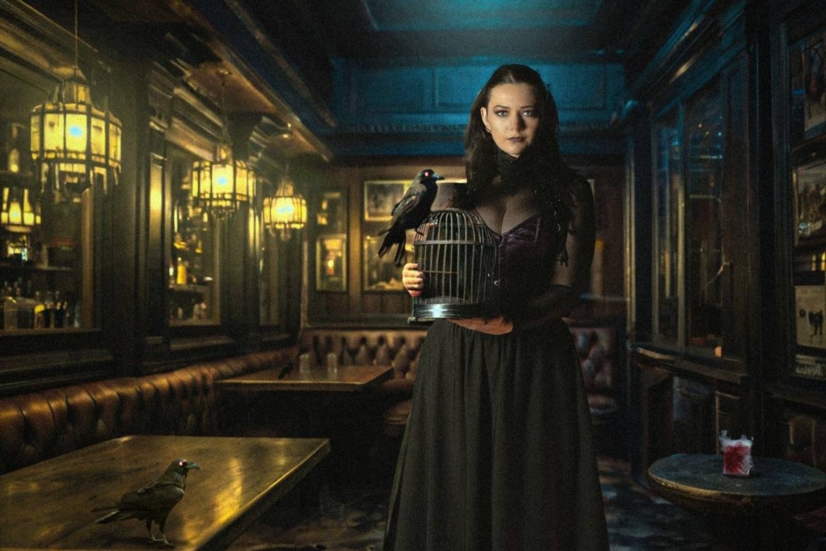 woman holding raven in dimly lit room