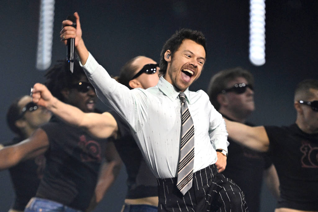 Image shows Harry Styles performing on stage.