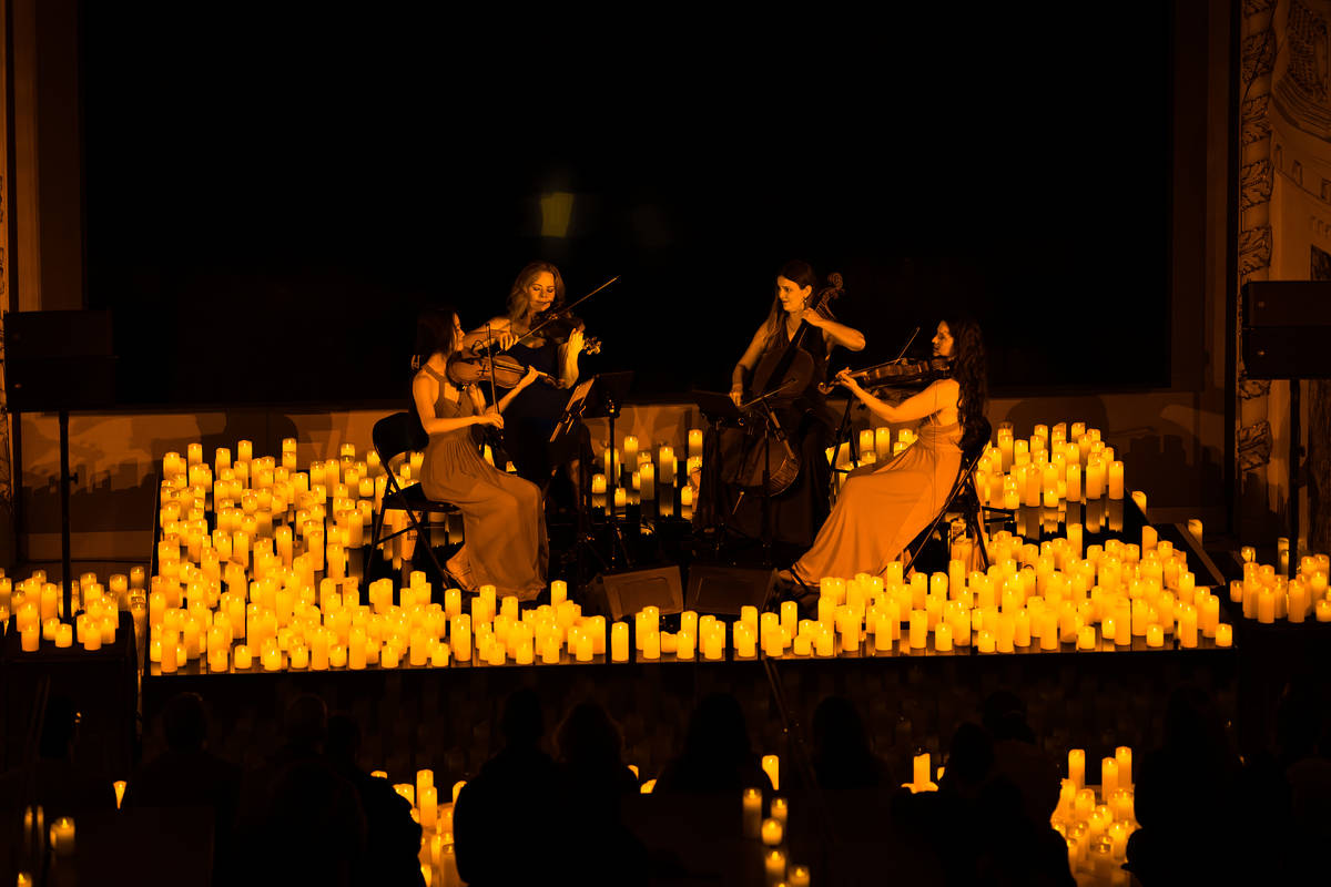 A string quartet play surrounded by thousands of candles.