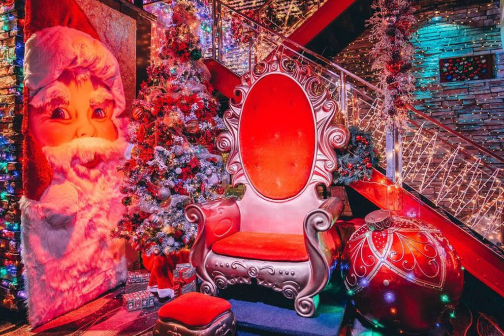 Image shows a Christmas themed chair at Frosty's Christmas bar surrounded by immersive decor.