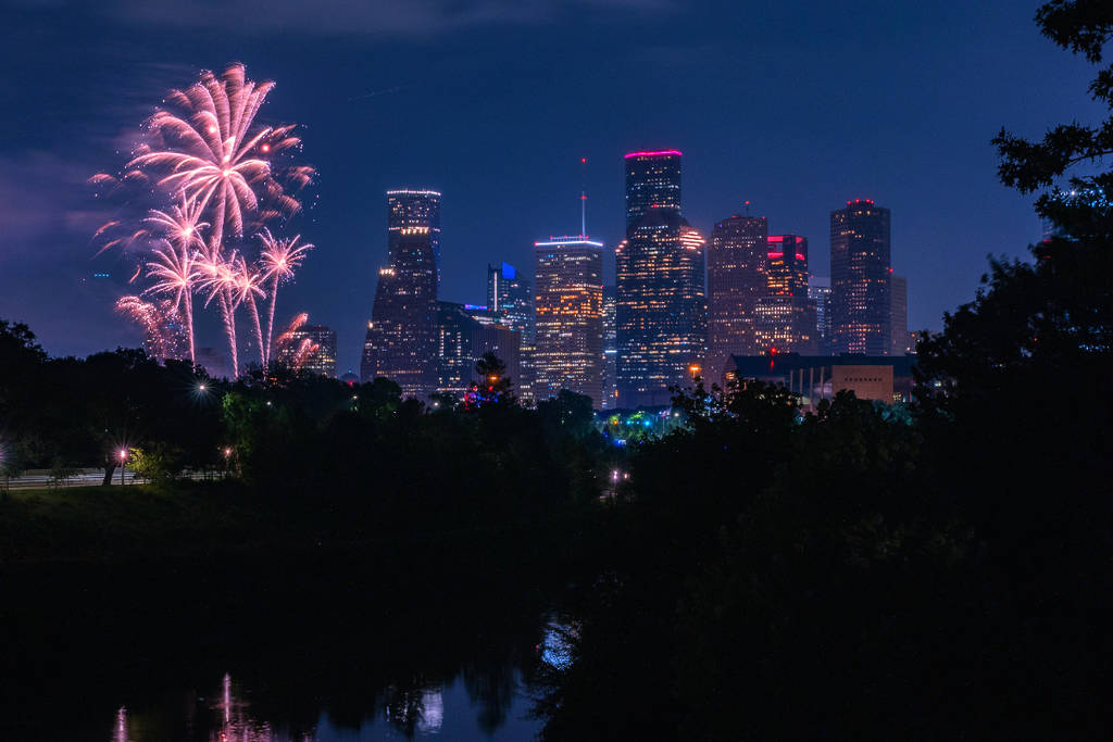 Image shows fireworks going up around the skyline in Houston for Fourth of July.
