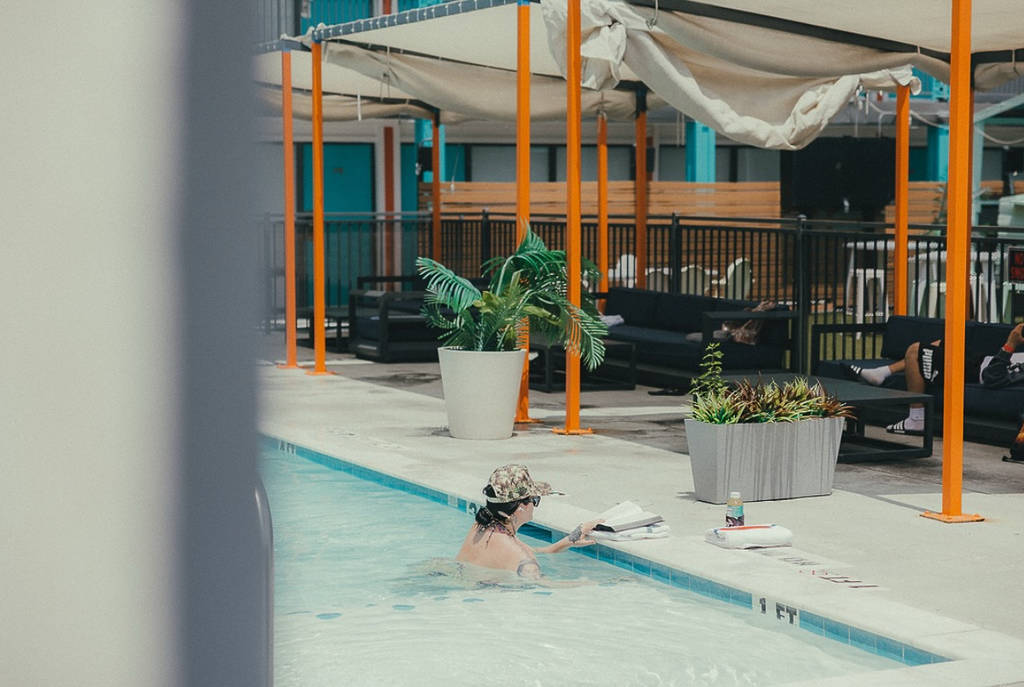 Image shows a patron in the pool at Heights House Hotel in Houston.