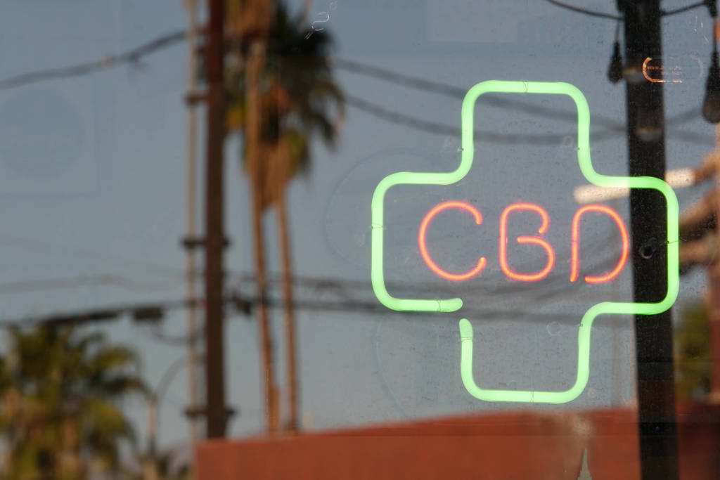 Image shows a window with a "CBD" neon.