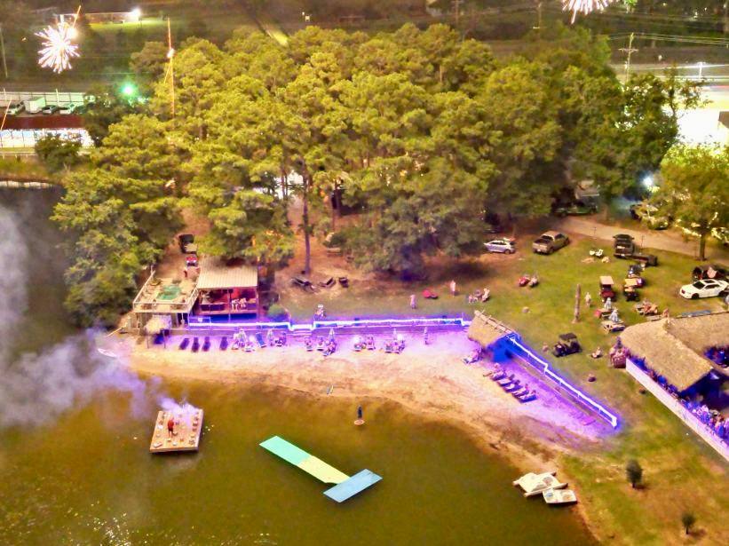 Image shows the beach and lake at Emerald Lakes Nature Resort in Houston.