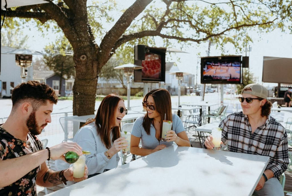 Image shows a group of friends hanging out at Drift Bar in Houston