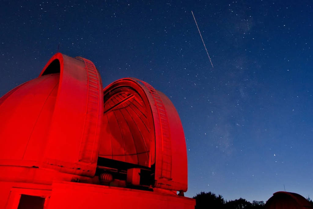 Image shows the George Observatory against the backdrop of a night sky.