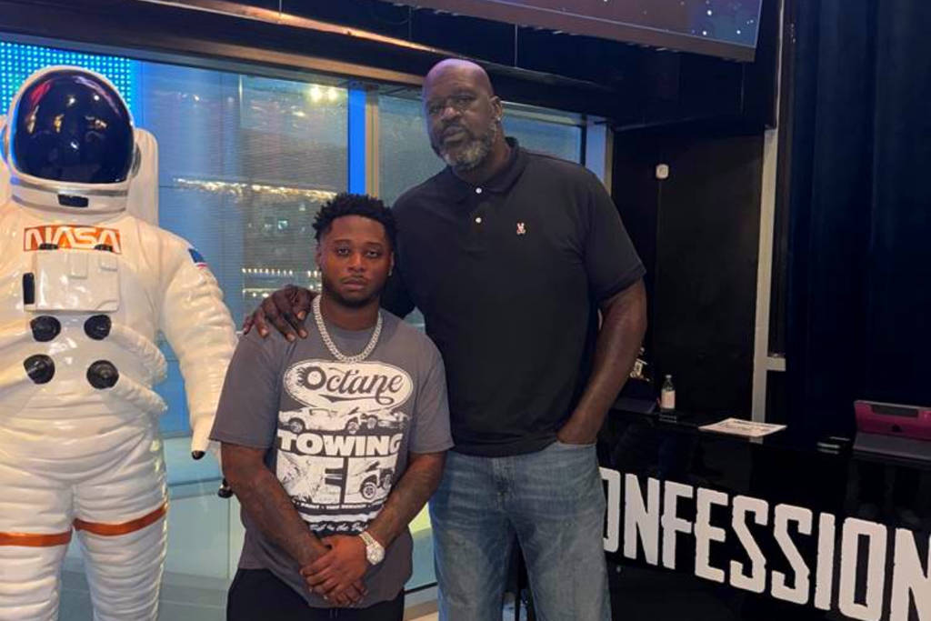 Image shows Confessons Restaurant & Lounge founder, Sterling Lewis, posing with Shaquille O'Neal