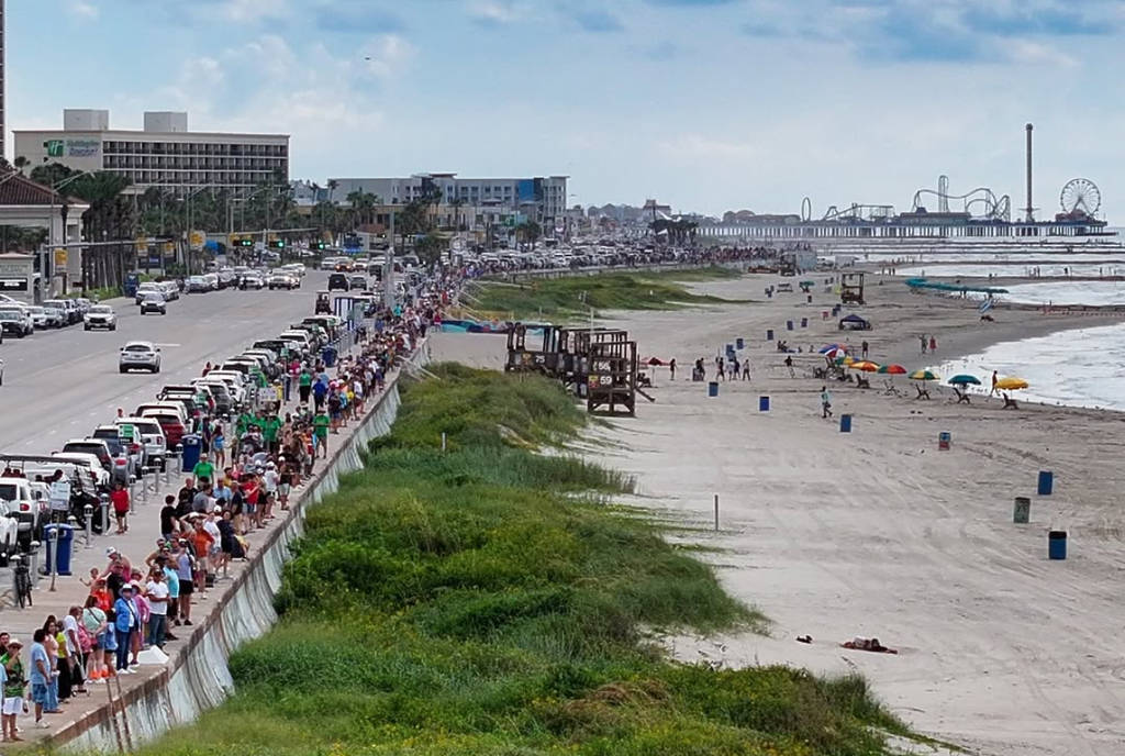 Image shows people in Galveston lining up along the seawall to break the Guinness World Record for the longest human walkway.