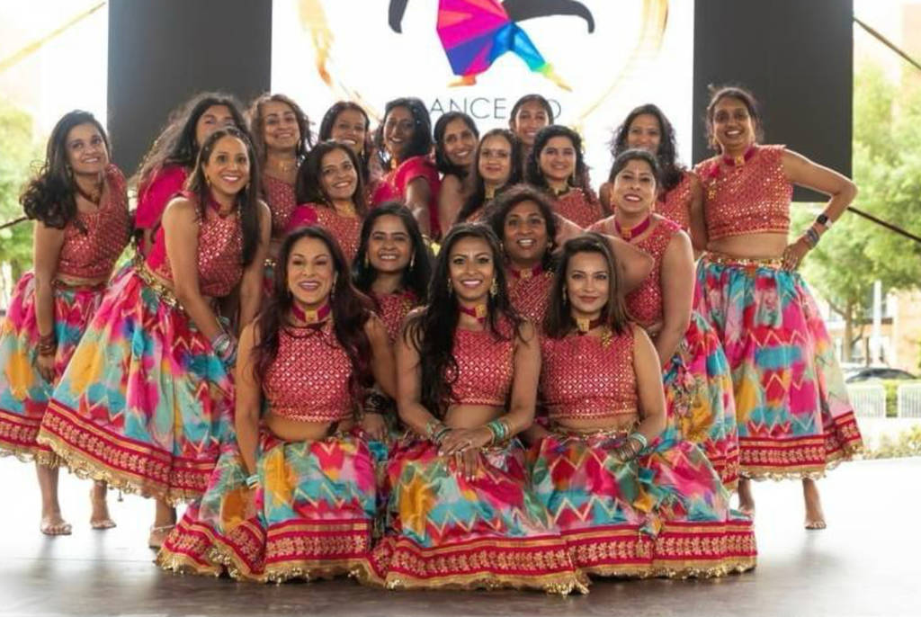 Image shows a Diwali dance group posing for a photo.