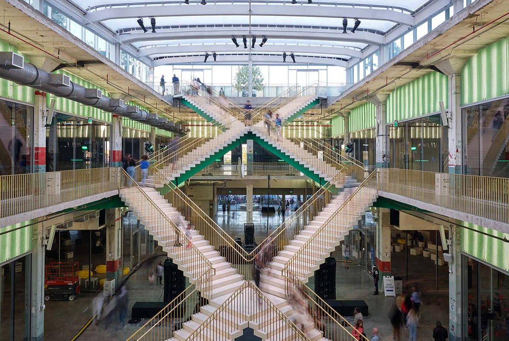 Image shows the interior of POST Houston and its double helix staircase.