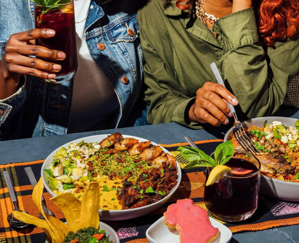 Image shows two women dining on West African cuisine at ChopnBlok in Houston