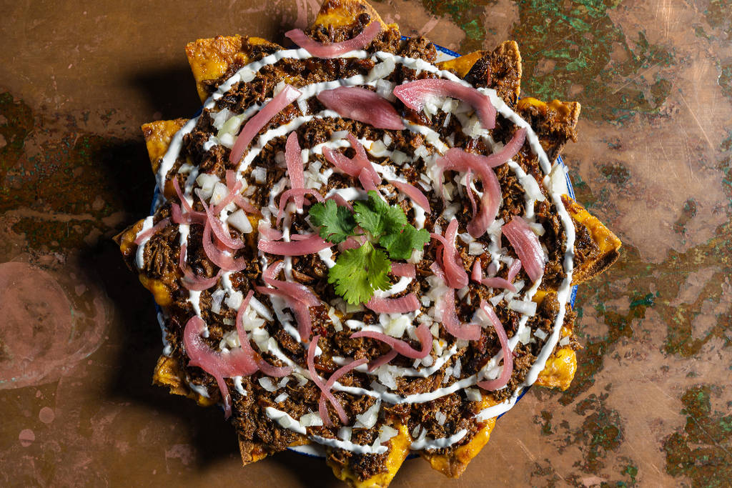 Image shows brisket nachos from Candente restaurant in Houston.