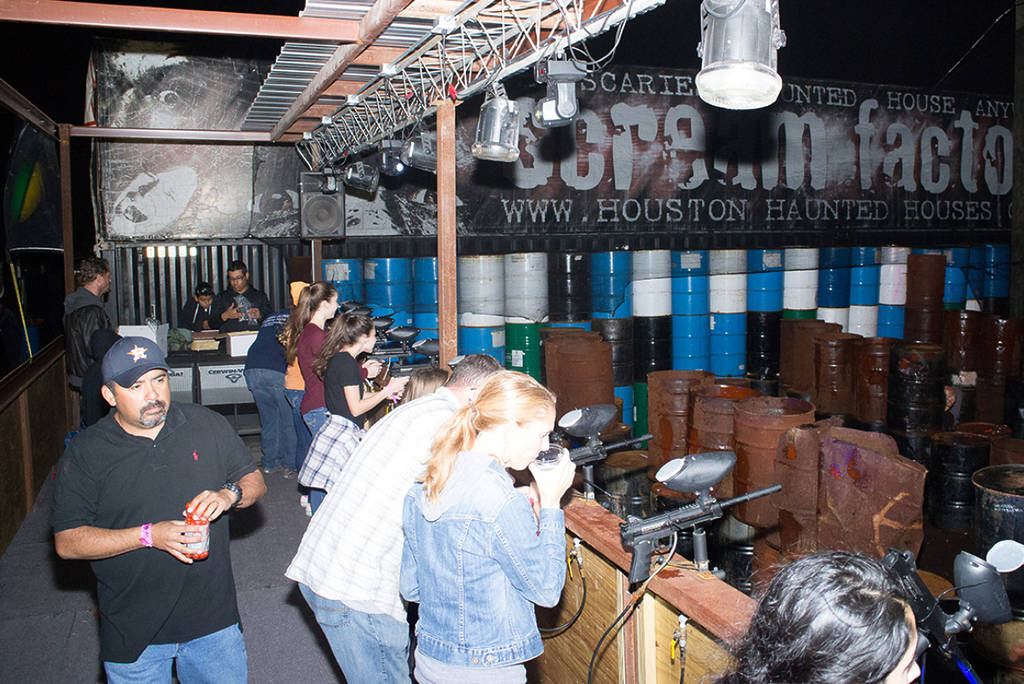 Image shows a group of people playing paintball at Scream Fest in Houston.