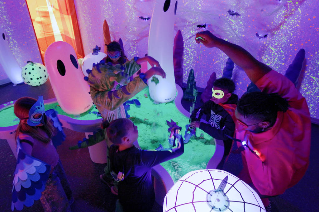 Image shows a group of kids playing at the Sloomoo Institute in Houston for its seasonal Halloween event.