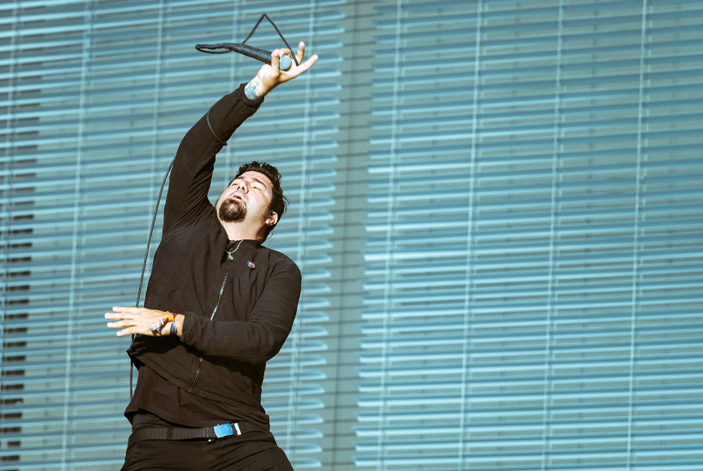 Image shows Chino Moreno of the band, Deftones, performing on stage.