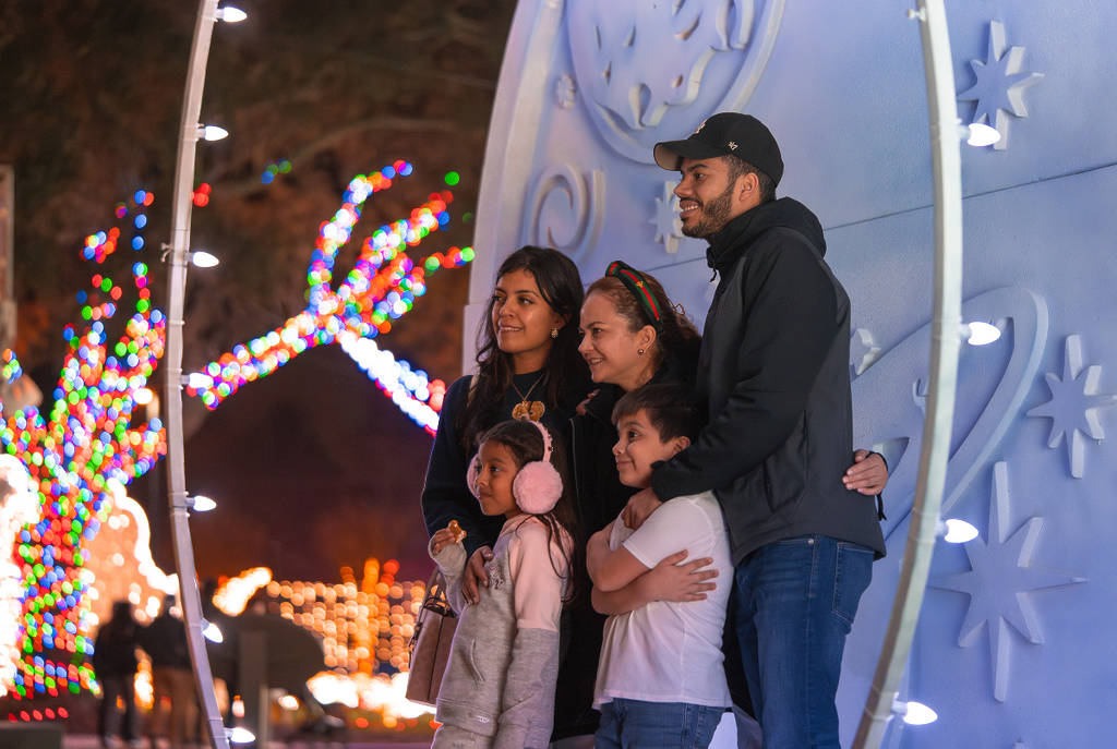 Image shows a family posing for a photo at Galaxy Lights Space Center Houston.