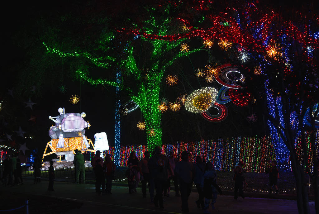 Image shows the cosmic Christmas light decorations at Galaxy Lights Space Center Houston.