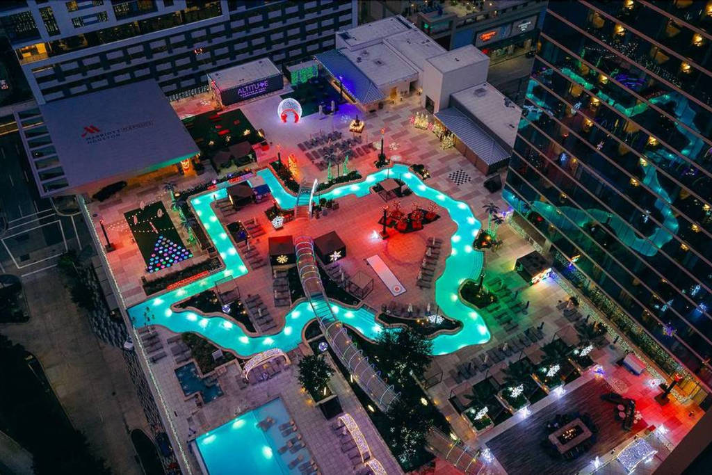 Image shows the lazy river atop Marriot Marquis Houston illuminated in holiday activation: Texas Winter Lights.