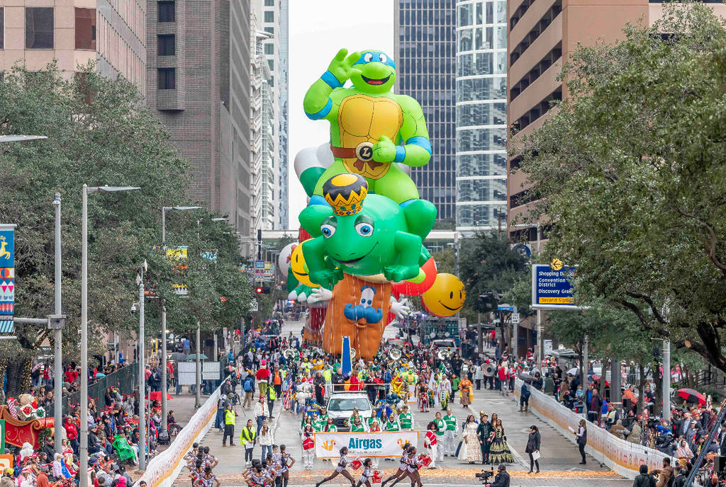 Image shows an array of floats and crowds at the Houston Thanksgiving Day Parade.