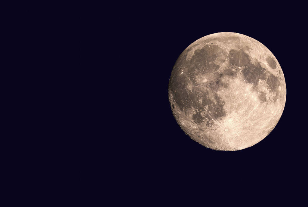 Image shows a supermoon in the night sky.