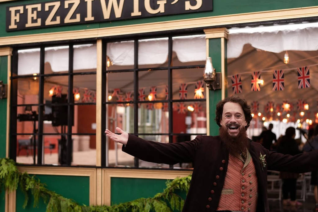 Image shows a man dressed in period Victorian ware outside a beer hall.