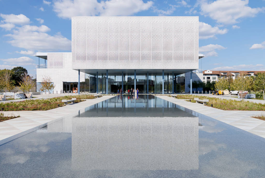 Image shows a reflection pool and face of the Ismaili Center in Houston.