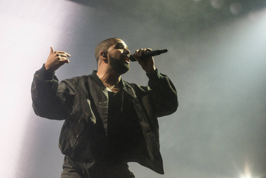 Image shows Drake performing on stage.