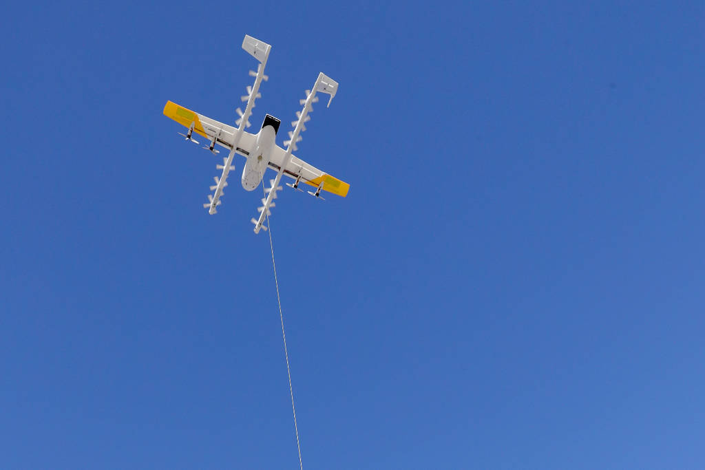 Image shows a Walmart delivery drone in the sky.