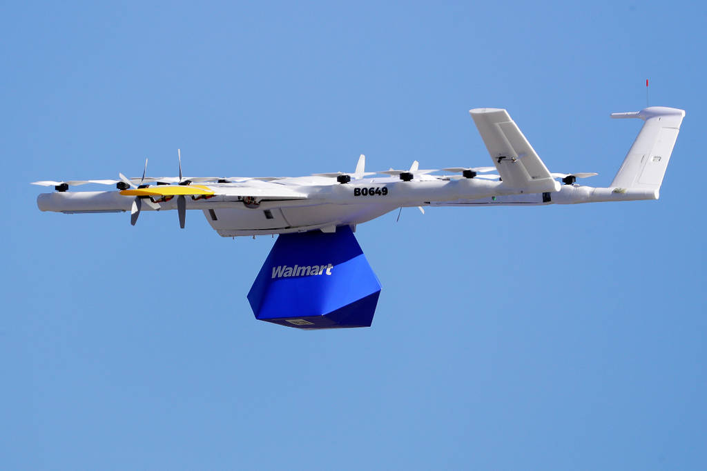 Image shows a Walmart delivery drone with goods underneath.