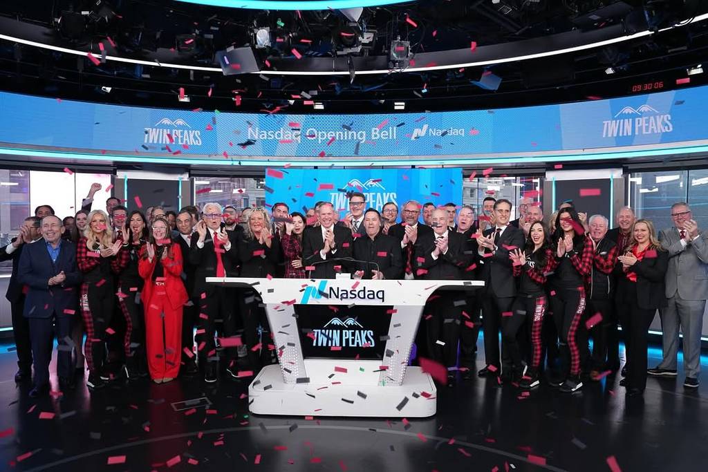 Image shows people cheering around a Nasdaq platform featuring the Twin Peaks logo as confetti falls from the ceiling.
