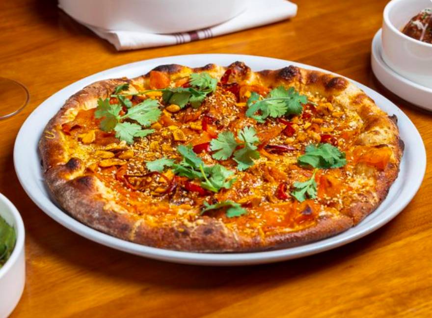 Image shows the Roasted Carrot Pizza from Weights + Measures in Houston.