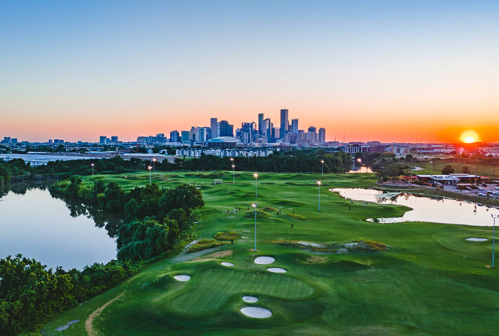 Image shows the East River 9 golf course in Houston with the skyline in the background.