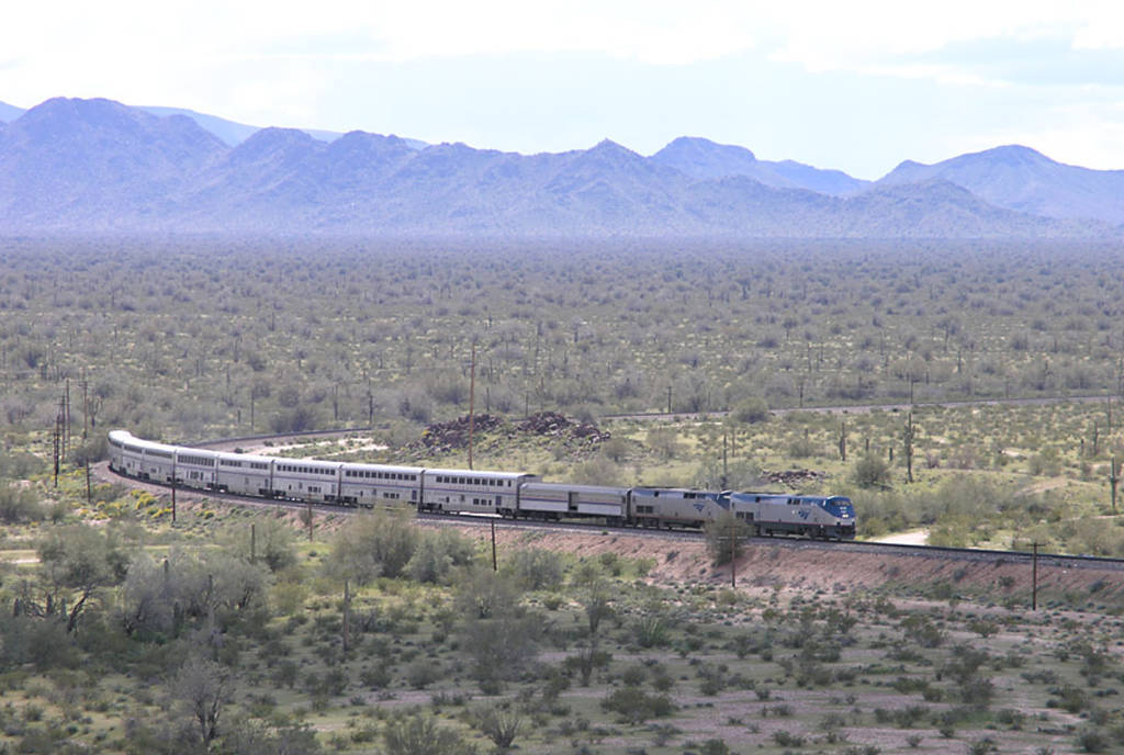 Image shows the Sunset Limited in the south with mountains in the background.