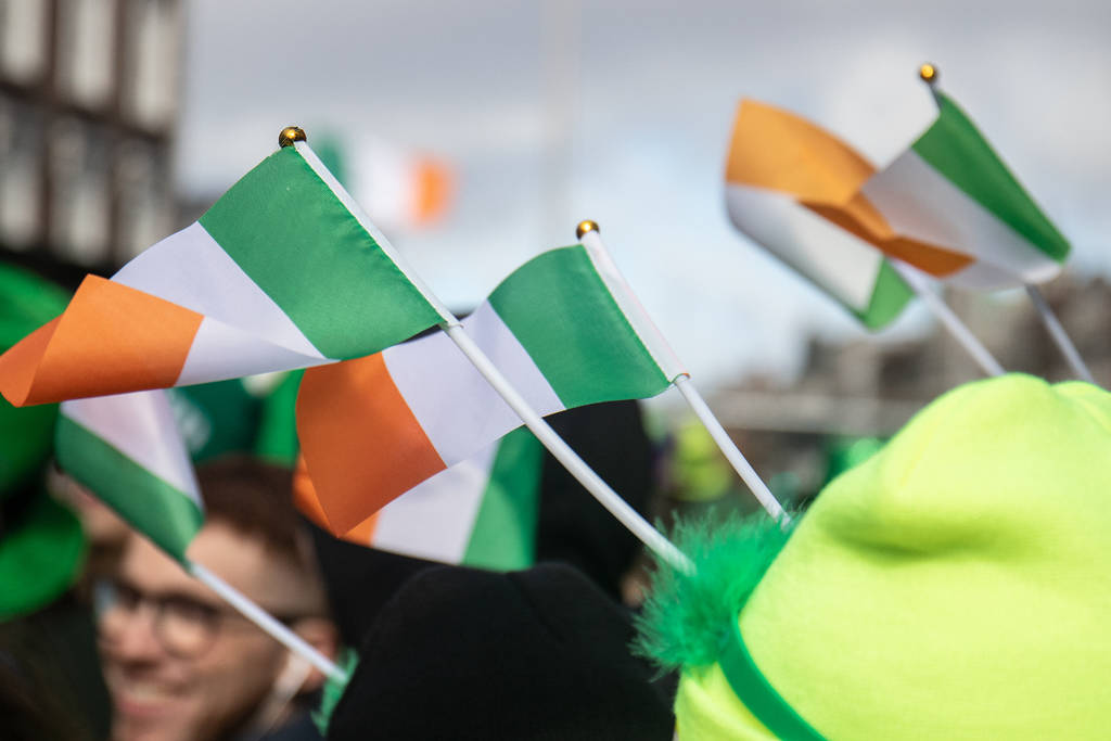 Images shows a trio of Irish flags at an event.