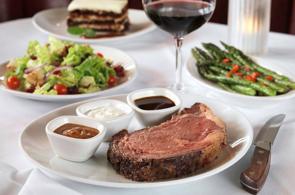 Image shows a prime rib plated at Fleming's Prime Steakhouse & Wine Bar