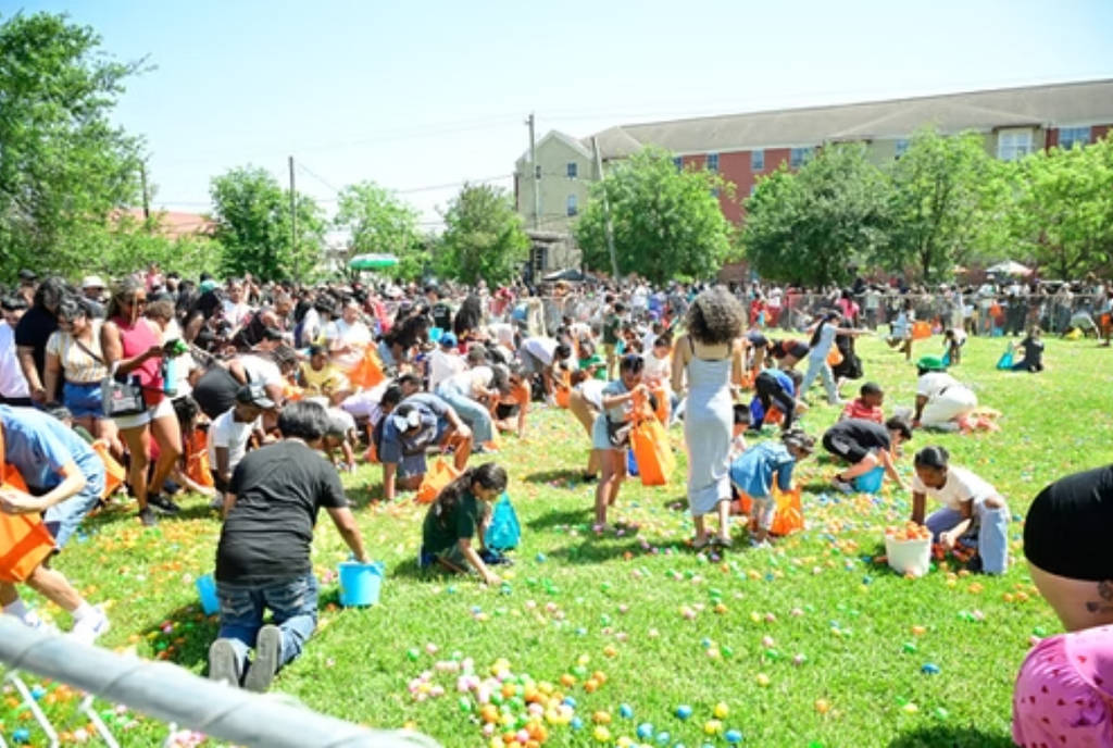 Image shows kids Easter egg hunting at the Lyons Avenue Renaissance Festival.